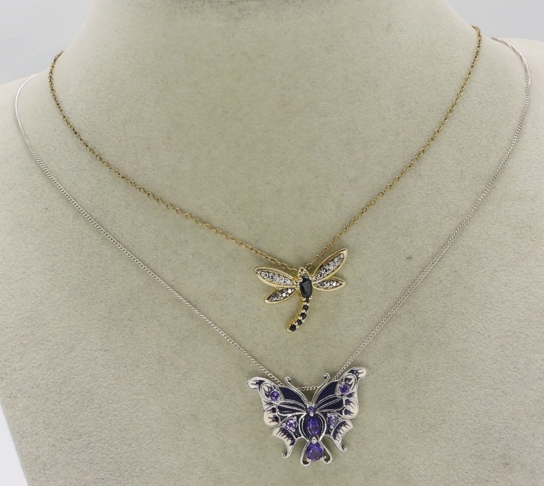 Beautiful Butterfly & Dragonfly 925 Necklaces: Two sterling necklaces, one gold toned. Dragonfly has dark gemstones, possibly sapphires, 21" long chain. Butterfly with amethyst gemstones, white and purple enamel, on a 20" chain. (6.2 dwt)