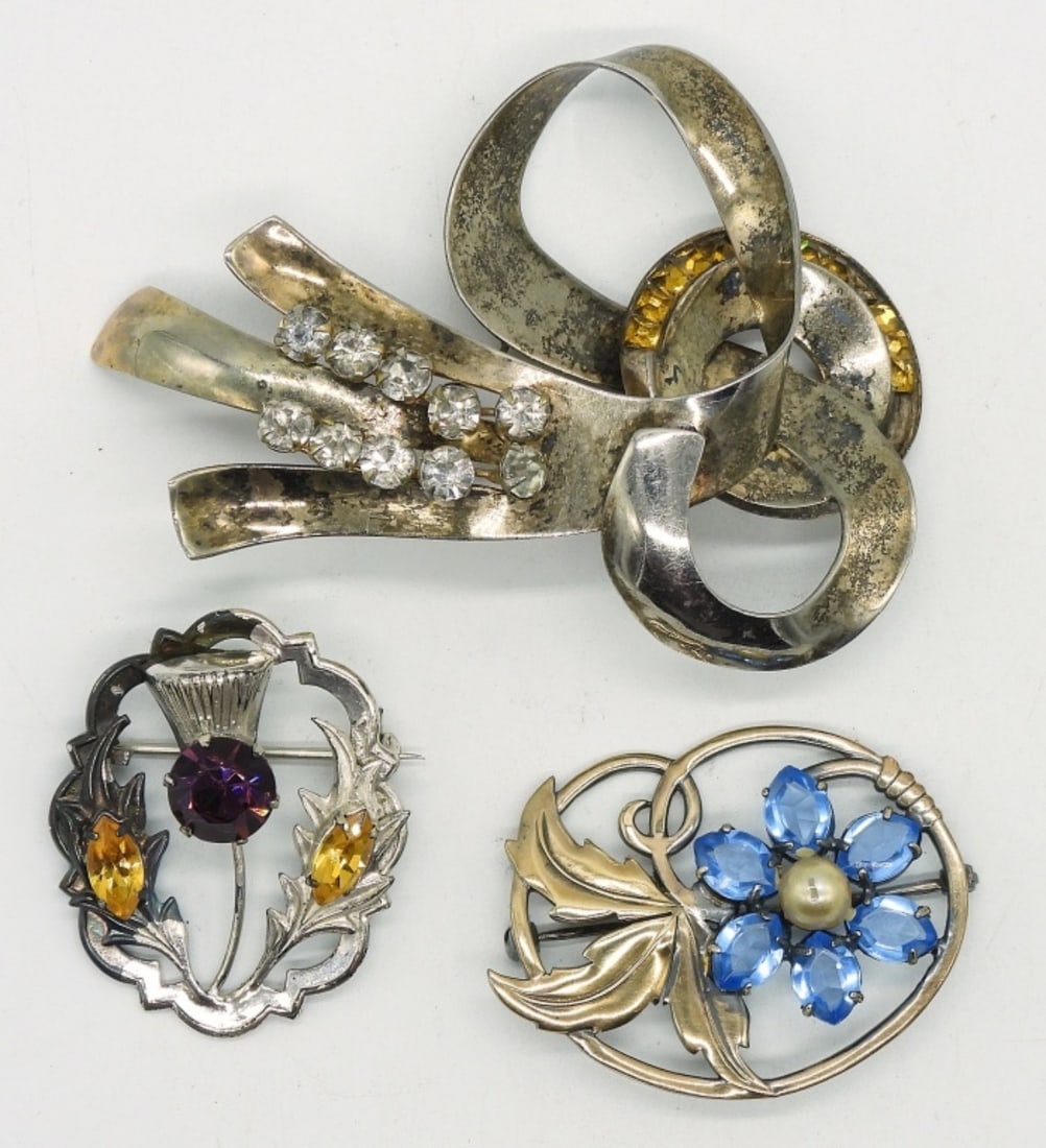 3 Vintage Sterling Brooches: Three sterling brooches with colored rhinestones. 2-3.5". (29 dwt)