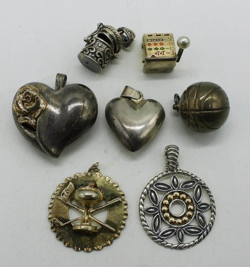 7 Sterling Pendants: Seven sterling pendants. 1/2" - 1.5". (24 dwt)