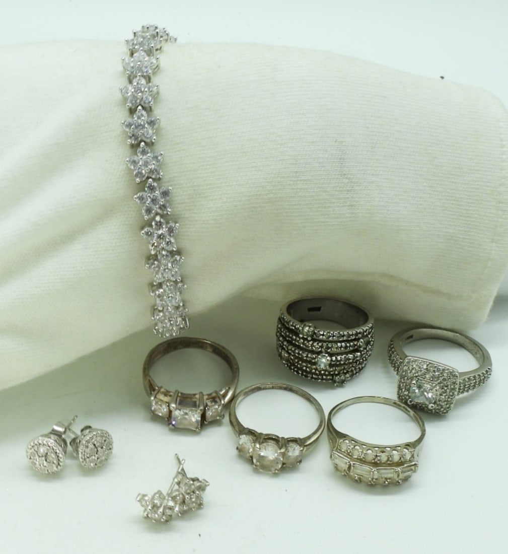 8 Piece Sterling Bridal Style Set: Eight piece sterling bridal style jewelry. Two pair of small pierced earrings. Simulated Diamond tennis bracelet, 7" long. Five sterling, simulated diamond rings. Sizes 8 & 9. (24 dwt)