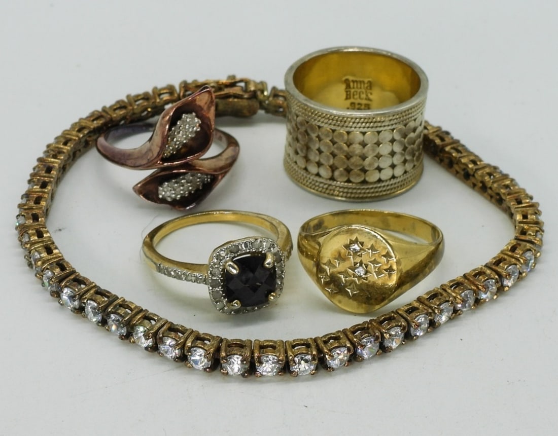 Gold Tone 925 Rings & Bracelet: Gold tone sterling rings, sizes 6-7. Sterling gold tone tennis bracelet with simulated diamonds, 7". (20.6 dwt)