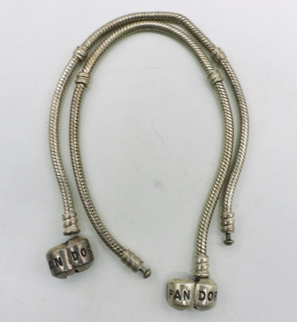Two Sterling Pandora Charm Bracelets: Two sterling pandora charm bracelets, no charms. Both 7" long. (17.6 dwt)