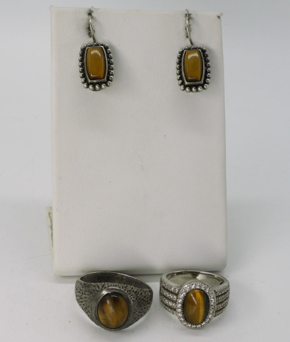 Vintage Tigers Eye 925 Rings & Earrings: Two vintage sterling rings with tigers eye gemstones, sizes 8 & 12. Simulated diamonds on the ladies ring. One pair of sterling pierced, tigers eye earrings, 1" long. (13 dwt) (6x4x2)