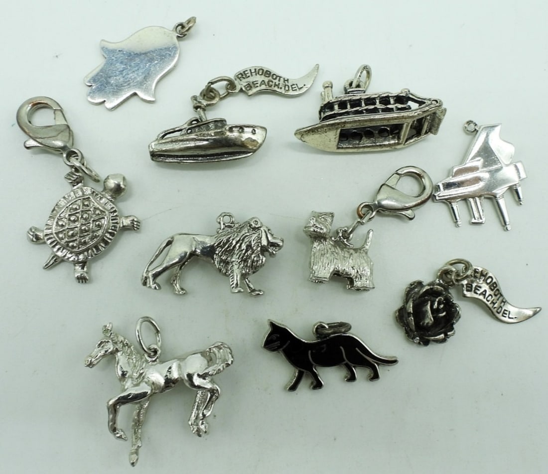 10 Sterling Modern & Vintage Charms: Ten sterling modern and vintage charms. (17.6 dwt) (6x4x2)