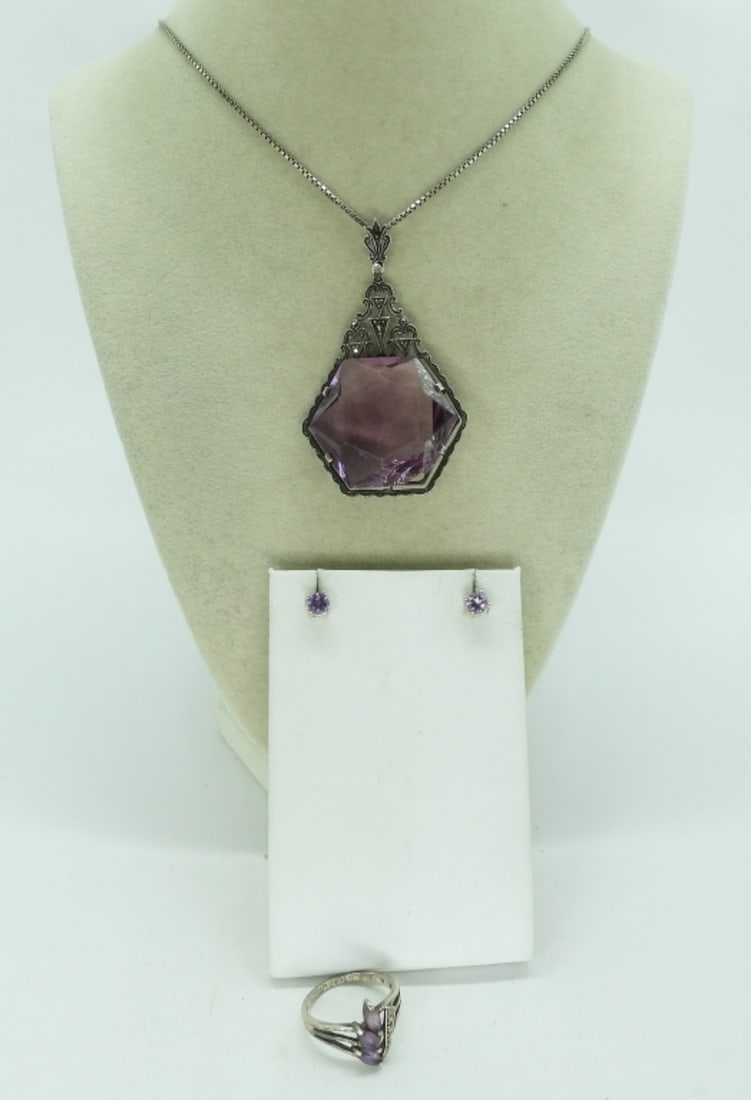 Art Deco Sterling Purple Gemstone Necklace: Art Deco, sterling purple gemstone necklace. Purple stone is missing a chunk at the bottom. See photos. 20" long. Amethyst ring, size 8. Pierced earrings. (17.2 dwt) (6x4x2)