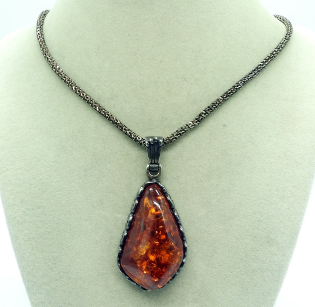 Large Amber Gemstone Sterling Necklace: Sterling necklace with a large amber gemstone. Pendant is 3" long, 1.5" wide. Sterling chain is 20" long. (20 dwt) (6x4x2)