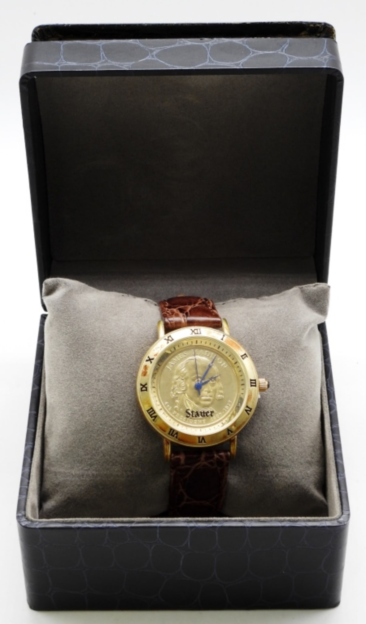 Stauer James Madison Watch: Genuine brown leather. Comes in the original box. ( The top of the lid is separating from the box.) The watch face does need a clean. Watches are not verified, authenticated, or tested in running