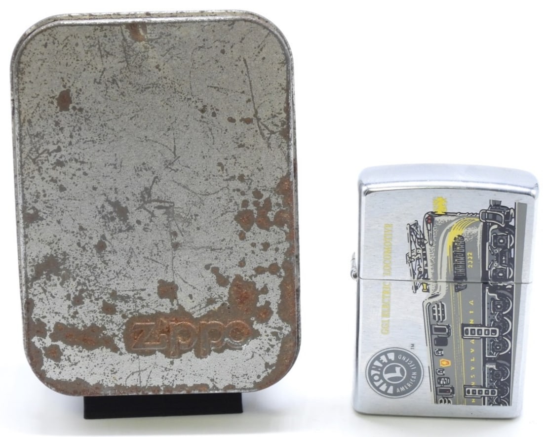 Lionel GG1 Electric Train Zippo Sealed 1999: Lionel American Legend. GG1 Electric Locomotive on the front of the Zippo. In a tin case that has been worn from the years.