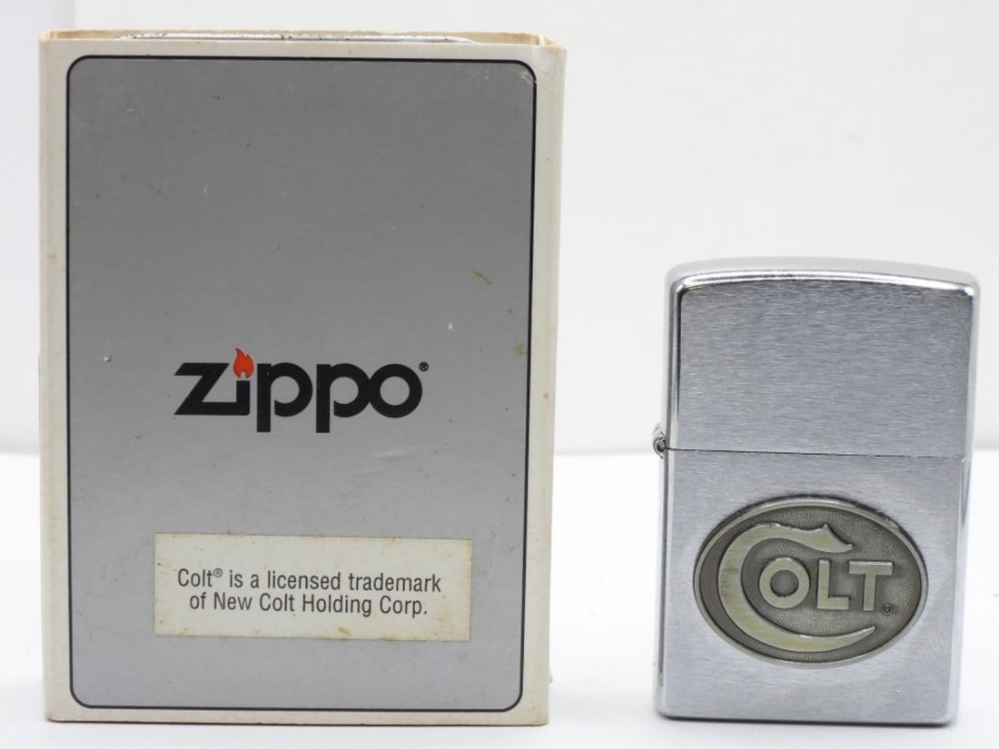 1997 Colt Logo Zippo Unfired: Comes in a tin case. Colt Logo emblem on the front.