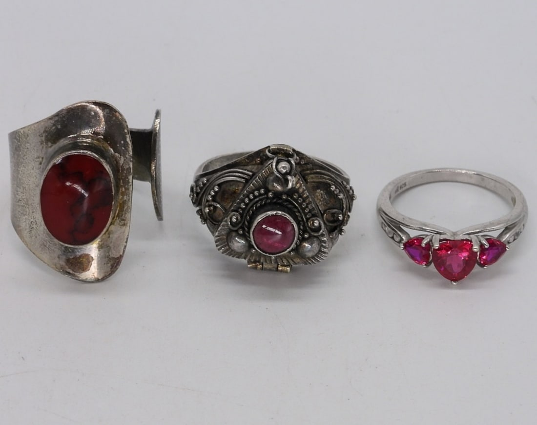 Red Jasper Vintage Ring & Other 925 Rings: Three sterling rings, vintage red jasper, adjustable size. Garnet poison ring, size 8. Simulated ruby heart ring, size 7. (11.7 dwt)