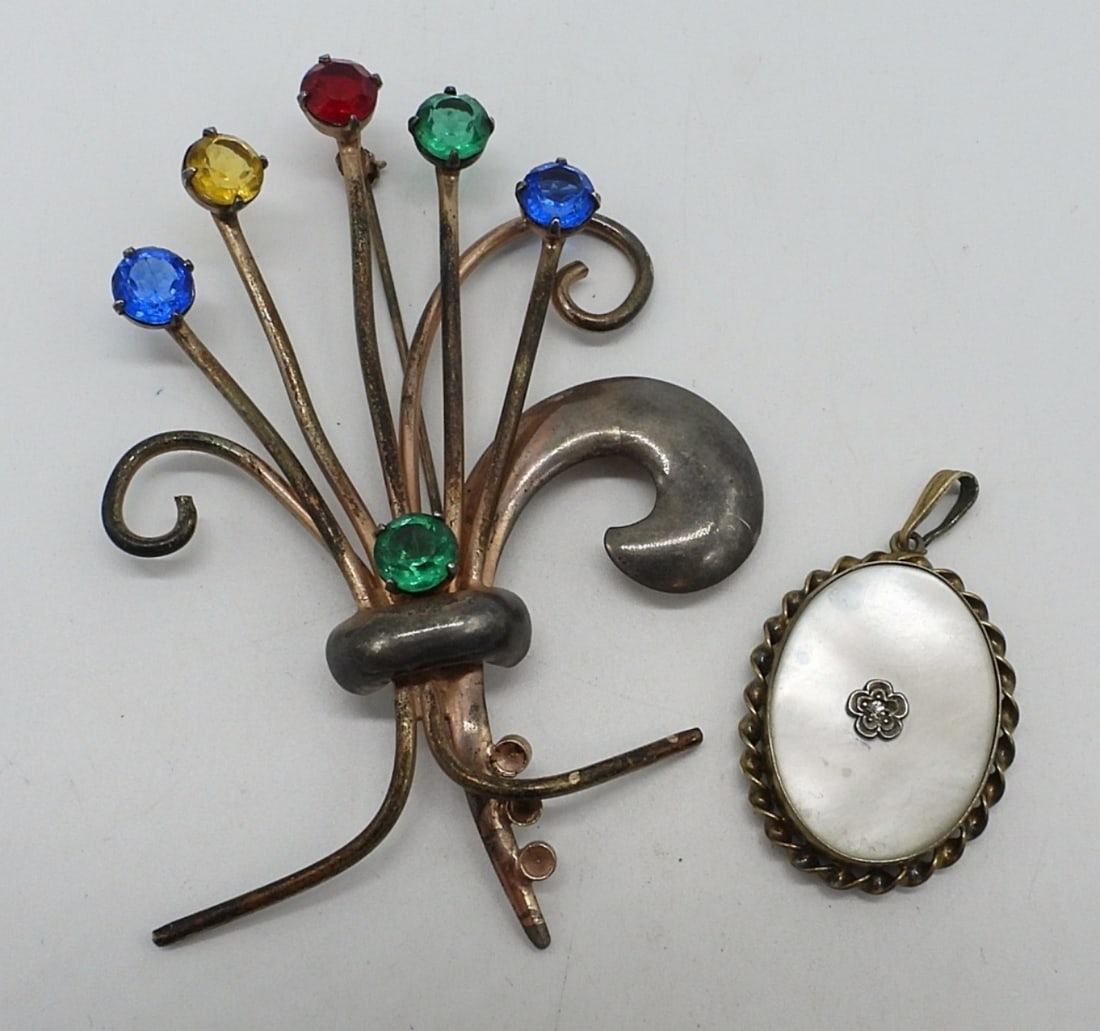 Antique Mother of Pearl Locket & Brooch: Antique 1/20 10k on Sterling "AMCO" locket with mother of pearl face. Locket open on the back, 1.5" long. (locket hinge is loose). Vintage sterling gold tone brooch with colorful rhinestones, 3" long.
