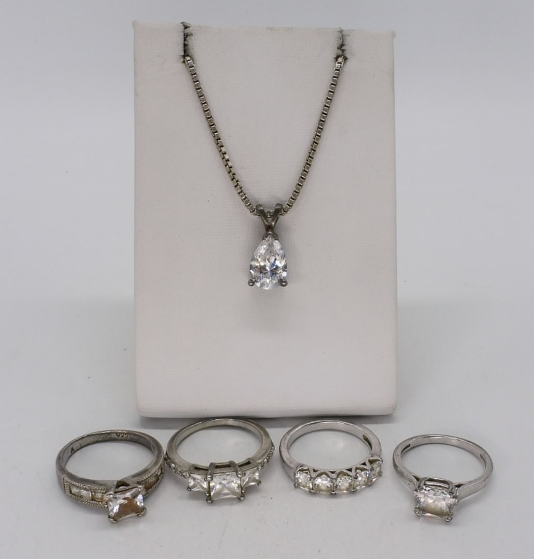 Bridal Style 925 Rings and Necklace: Four bridal style rings with simulated diamond gemstones. Sizes 7 & 8. Simulated diamond pear shaped necklace, 16" long. (10.7 dwt)
