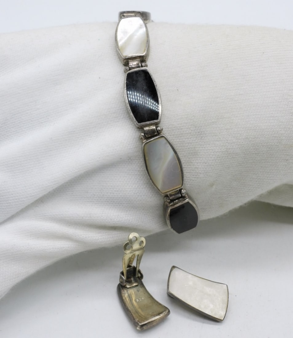 Black Onyx & Mother of Pearl Bracelet: Black onyx and mother of pearl bracelet, 7" long. Vintage sterling mother of pearl clip on earrings, 1" long. (14 dwt)