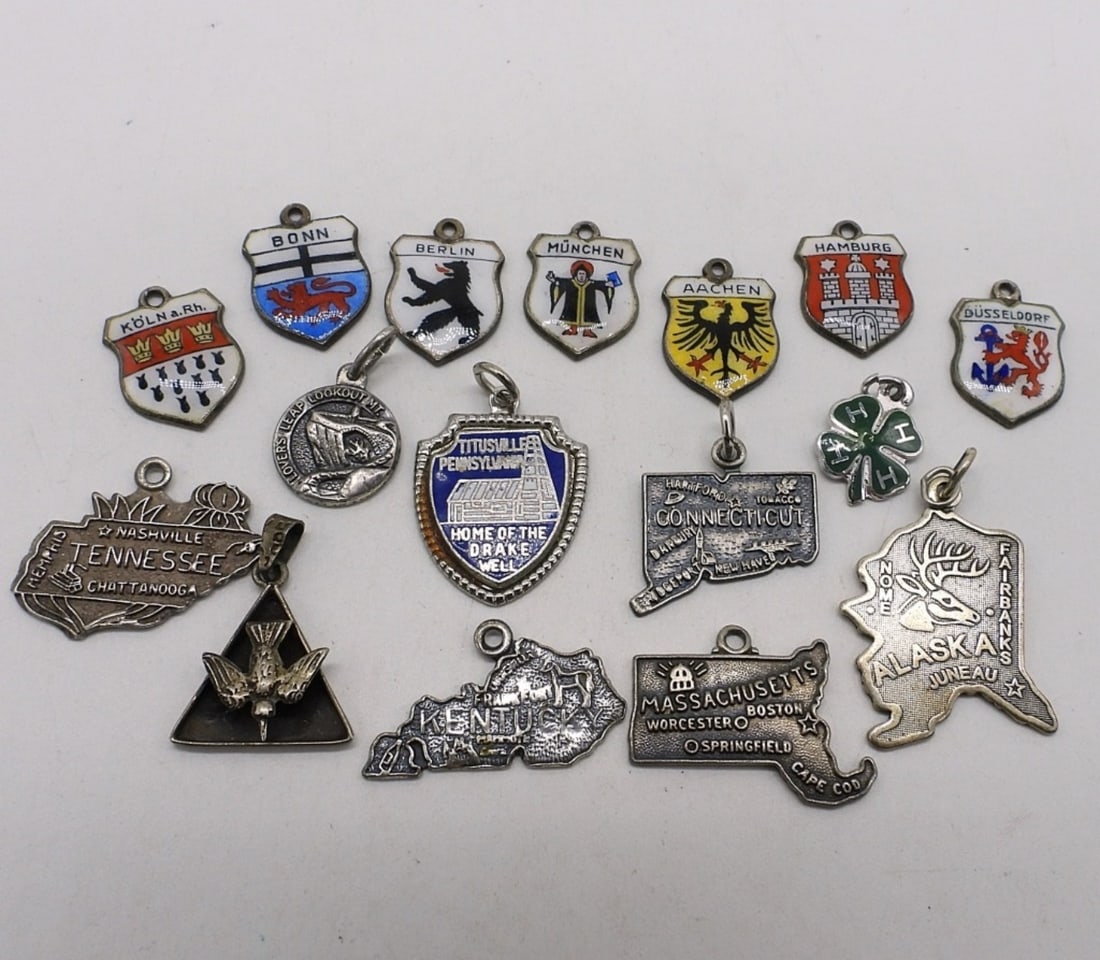 16 Vintage Sterling Charms: Sixteen vintage sterling charms. (14 dwt)