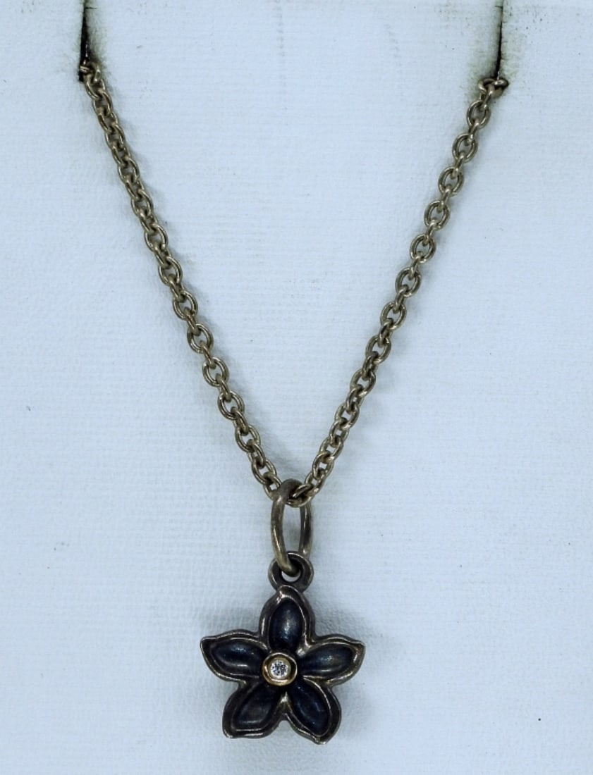 Pandora "He Loves Me" Diamond Necklace: Pandora brand, "He Loves Me" design. Tiny diamond in the center of a flower. Sterling chain is 24" long. (6 dwt)