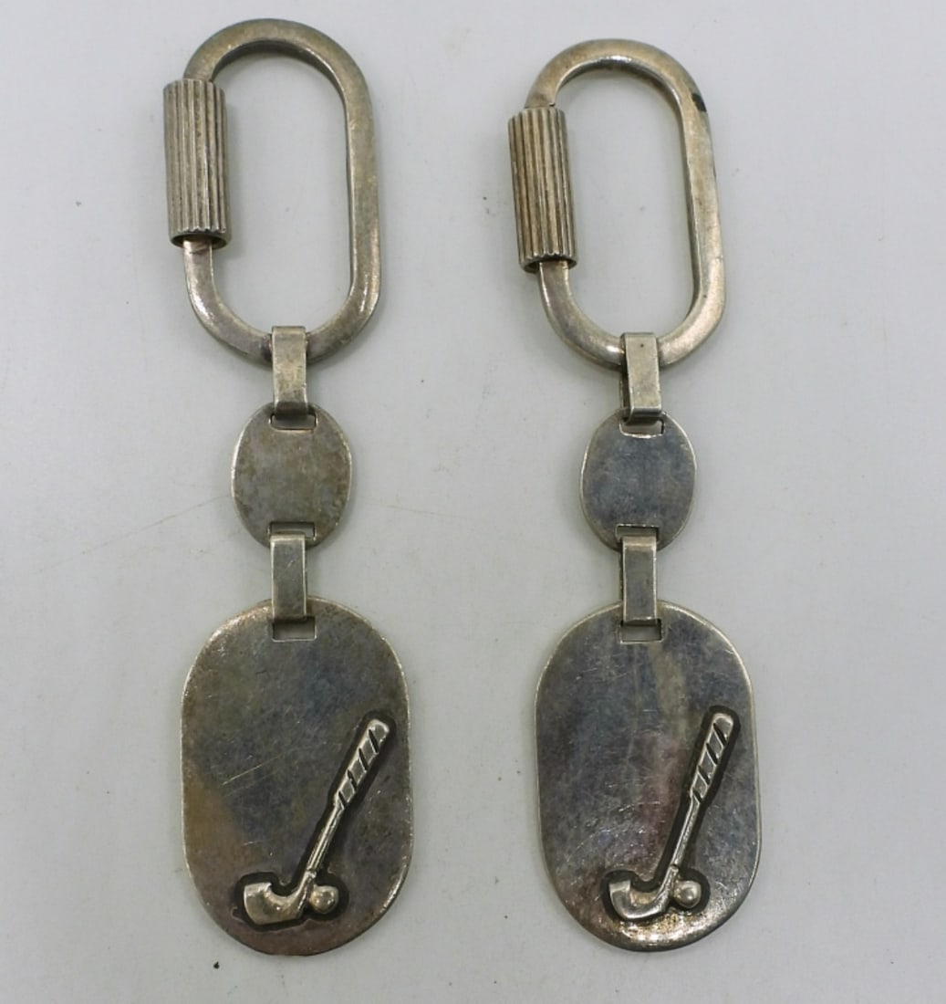 2 Sterling Golf Keychains: Two golf keychains, 4" long. (25.6 dwt)