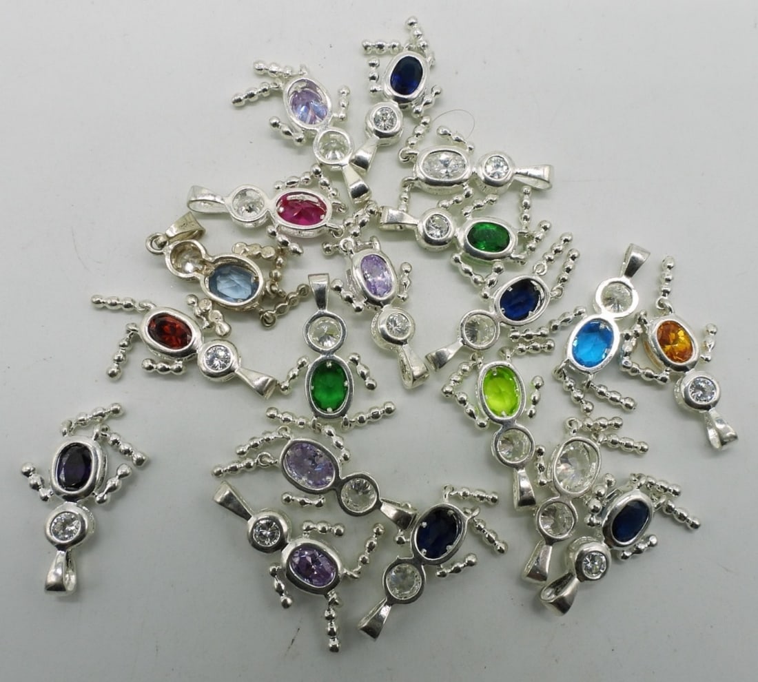 19 Sterling Birthstone Boy Pendants: Nineteen sterling birthstone boy pendants, 1 1/4" long. (23.8 dwt)