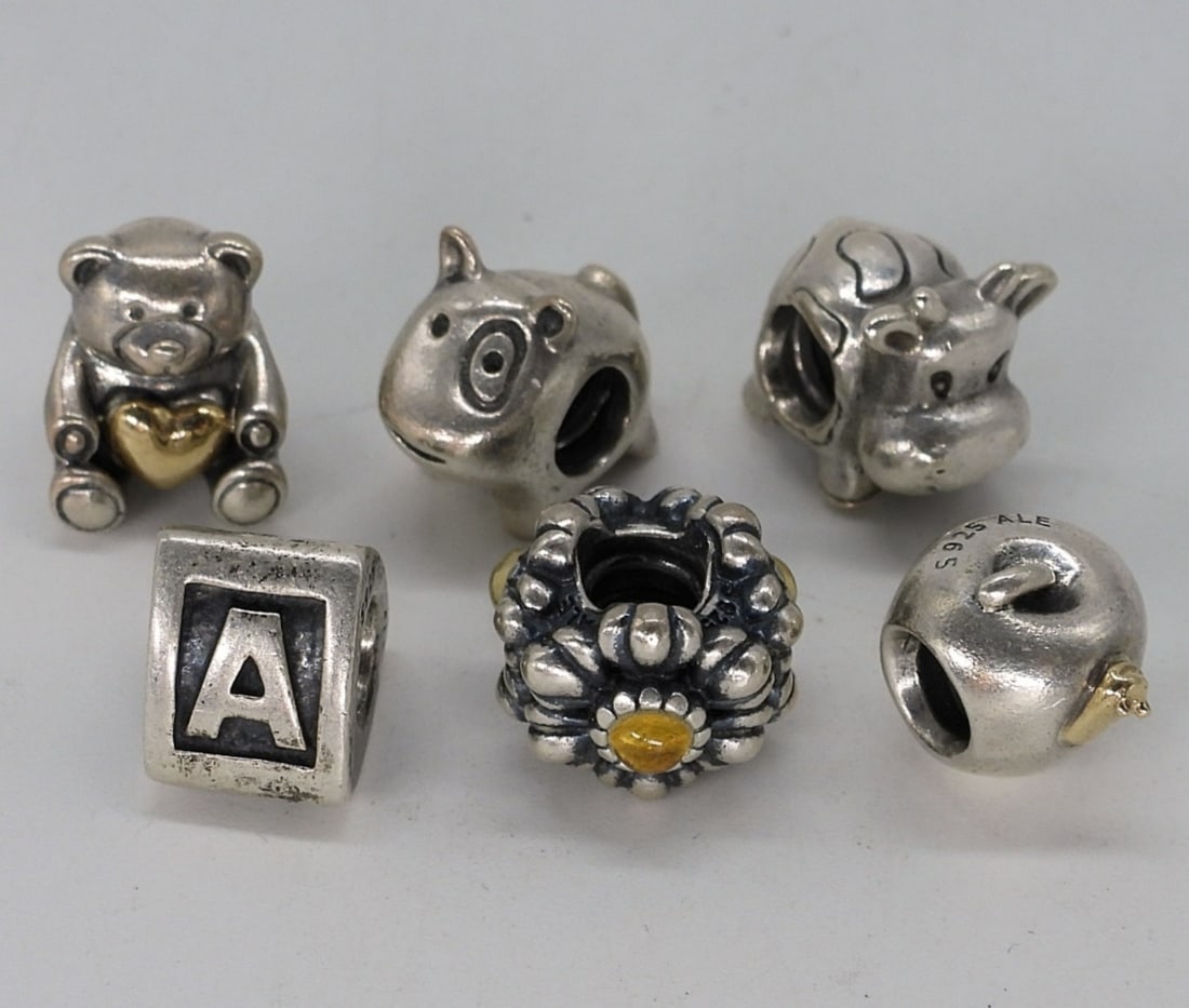 6 Sterling Charm Bracelet Beads: Six sterling charm bracelet beads. (15.8 dwt)