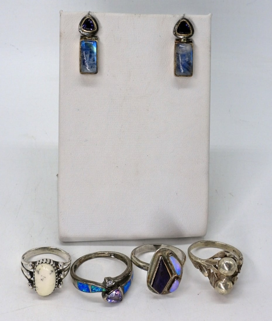 Moonstone, Opal, White Buffalo Turquoise 925: Four sterling rings and one pair of pierced earrings. White Buffalo Turquoise, Amethyst, Opal, Moonstone Gemstones. Ring sizes are 5.5 - 8.5. Earrings are amethyst & Moonstone, 1" long. (13 dwt)
