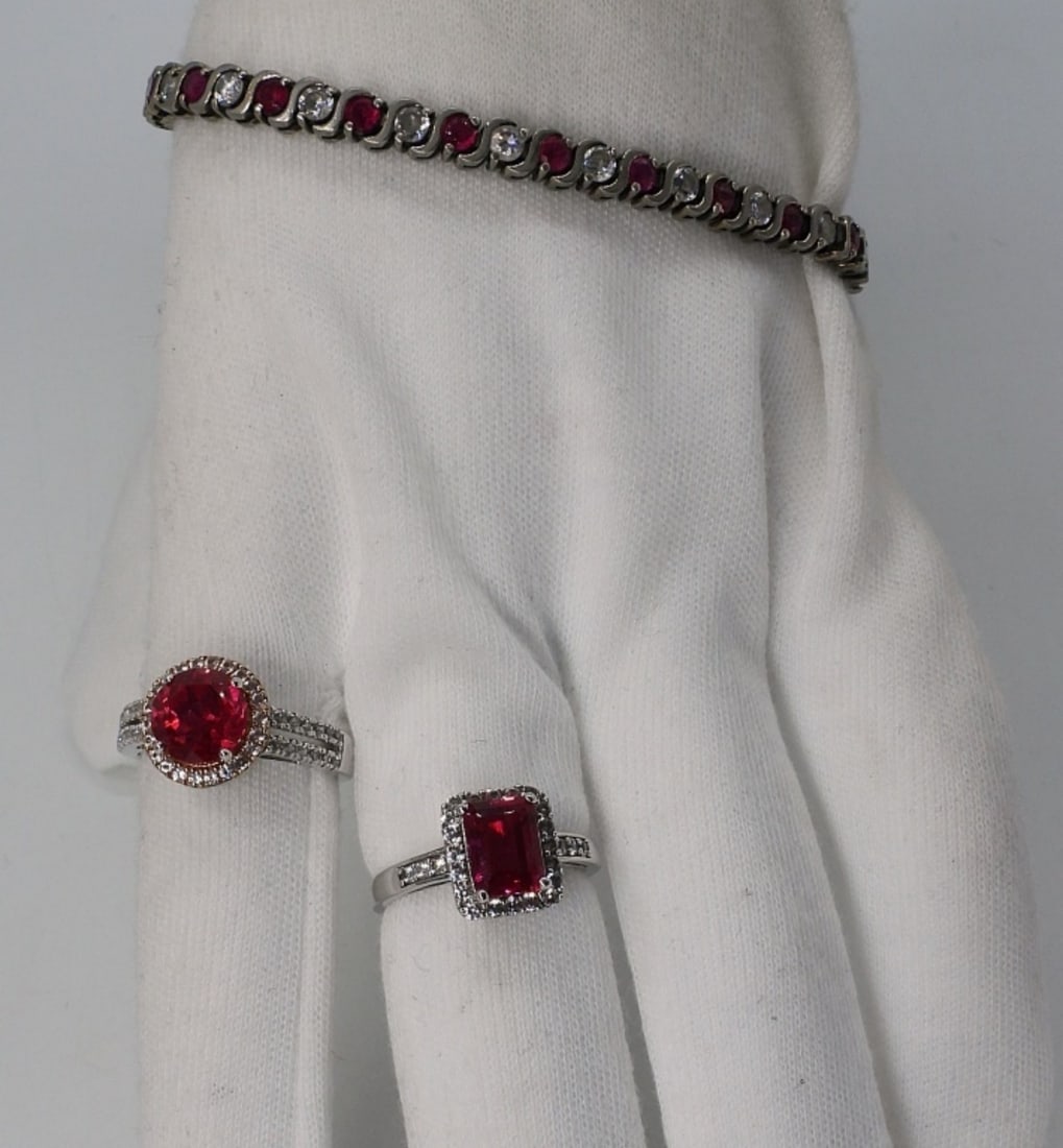 Simulated Ruby 925 Rings & Bracelet: Simulated Ruby & Diamond sterling bracelet 7" long. Two sterling simulated ruby rings, size 7. (13 dwt)