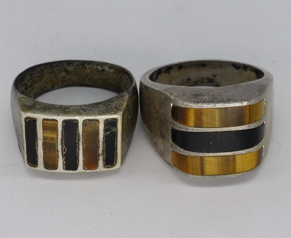 Taxco, Onyx, Tigers Eye Mens Rings: Two sterling mens rings. Both have black onyx and tigers eye gemstones. One is Taxco Mexico "TC-104". Sizes 14.5 & 11 (21.2 dwt)