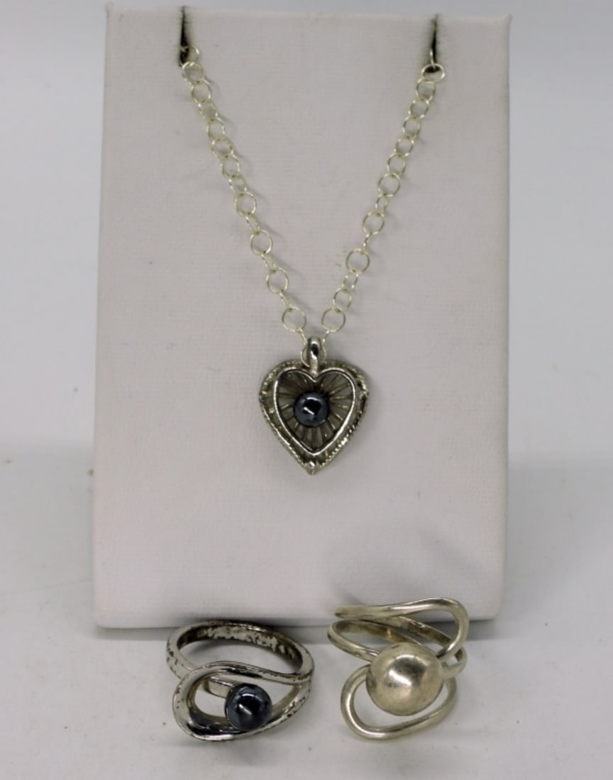 Hematite Sterling Rings & Necklace: Two sterling rings, size 7. One with a small hematite gemstone. Heart shaped necklace with a hematite gemstone center on a 18" sterling chain. (9.1 dwt)