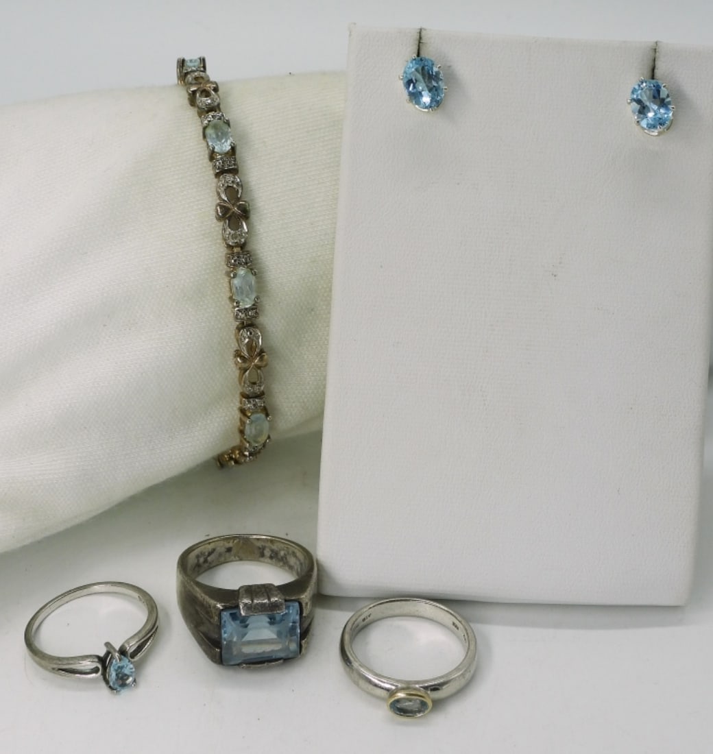 Blue Topaz Sterling Rings & More: Sterling jewelry with blue topaz gemstones. Bracelet is 7.5" long. Pierced earrings. Three sterling rings, sizes 7 & 9. (17 dwt)