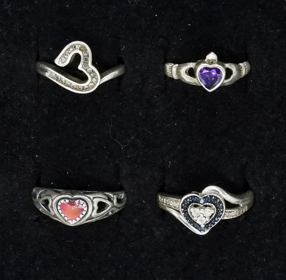Four Sterling Heart Shaped Fashion Rings: Four sterling heart shaped fashion rings, sizes 7, 8, 10. (8.7 dwt)