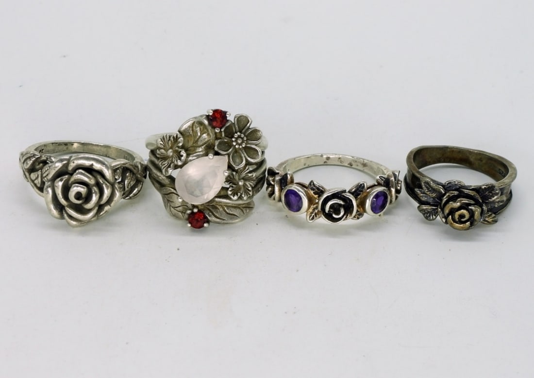 4 Sterling Rose Rings with Gemstones: Four sterling Rose rings with gemstones. Garnet & Amethyst. Sizes 6 & 7. (14 dwt)