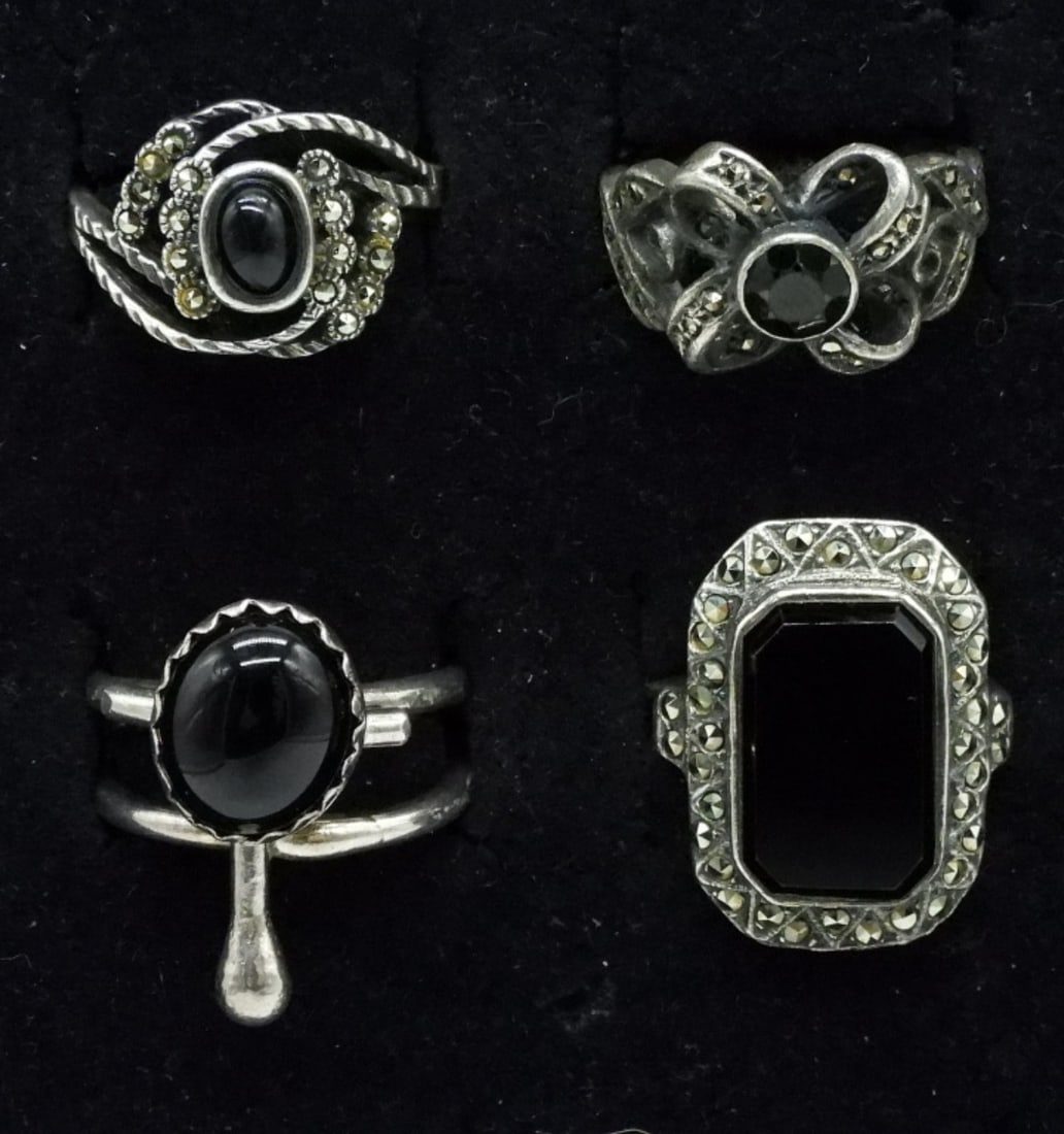 4 Sterling Black Onyx & Marcasite Rings: Four sterling rings with black onyx gemstones and marcasite. Sizes 4, 6, 7, 8. (13 dwt)
