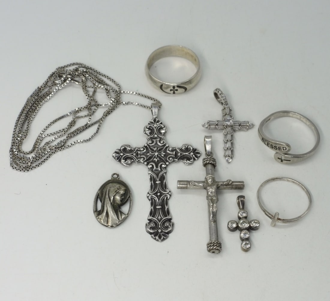 Religious Cross Sterling Pendants & Rings: Five sterling religious pendants, 1-2.5" long and one sterling chain 33". Three sterling religious rings, 6.5 & 9. (17 dwt)