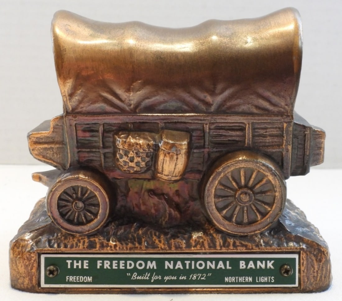 Diecast Covered Wagon Coin Bank: Small hole on one of the sides. In good condition