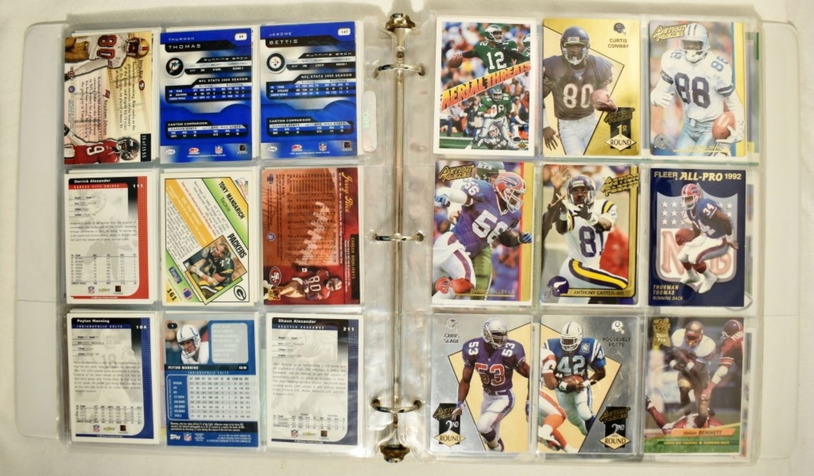 (22) Page Binder Of Football Cards 80s,90s,2000s: Troy Aikman, Barry Sander, Thurman Thomas and many more. Not completely full From the late 80s to the early 2000s. Conditions may vary. May have duplicates or reprints.