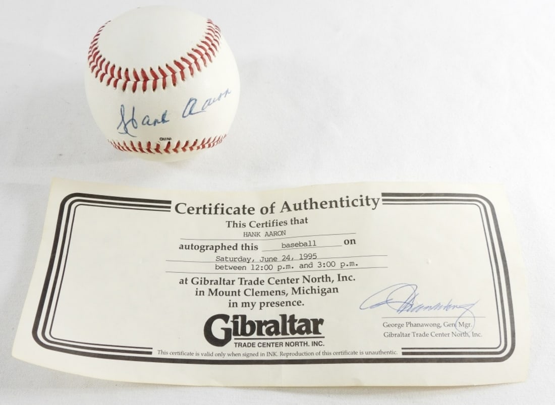 Hank Aaron Signed Baseball: In a case, in good condition.
