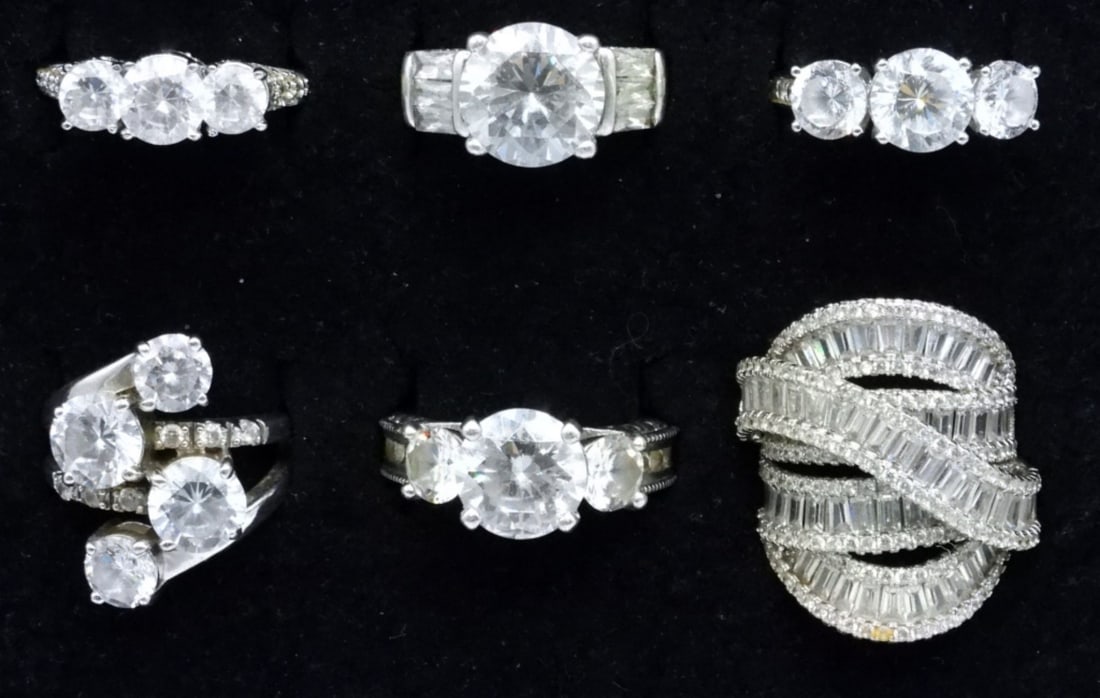6 Sterling Bridal Style Rings: Six sterling bridal style rings with large simulated diamond gemstones. Ring sizes are 6-8. (27 dwt)