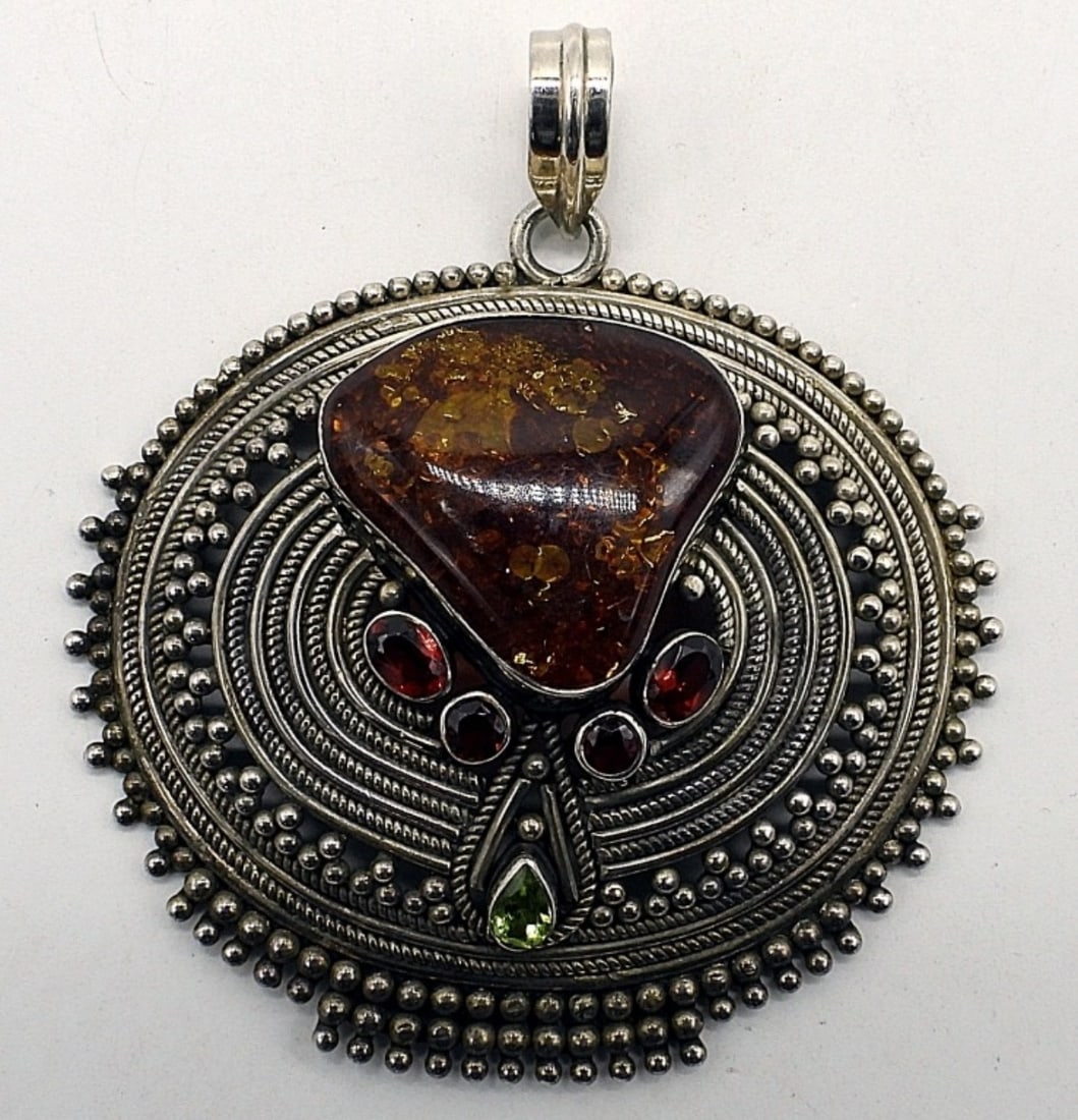 Large Ornate Sterling Amber Pendant: Large ornate sterling pendant with Amber, Garnet and Peridot gemstones. Pendant measures 3" wide and 2 3/4" long. (19.8 dwt)
