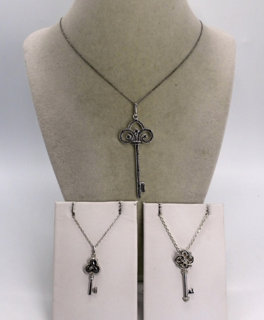 3 Sterling Skeleton Key Necklaces: Three sterling skeleton key necklaces. Chains are 14", 18" & 30" long. (13.5 dwt)