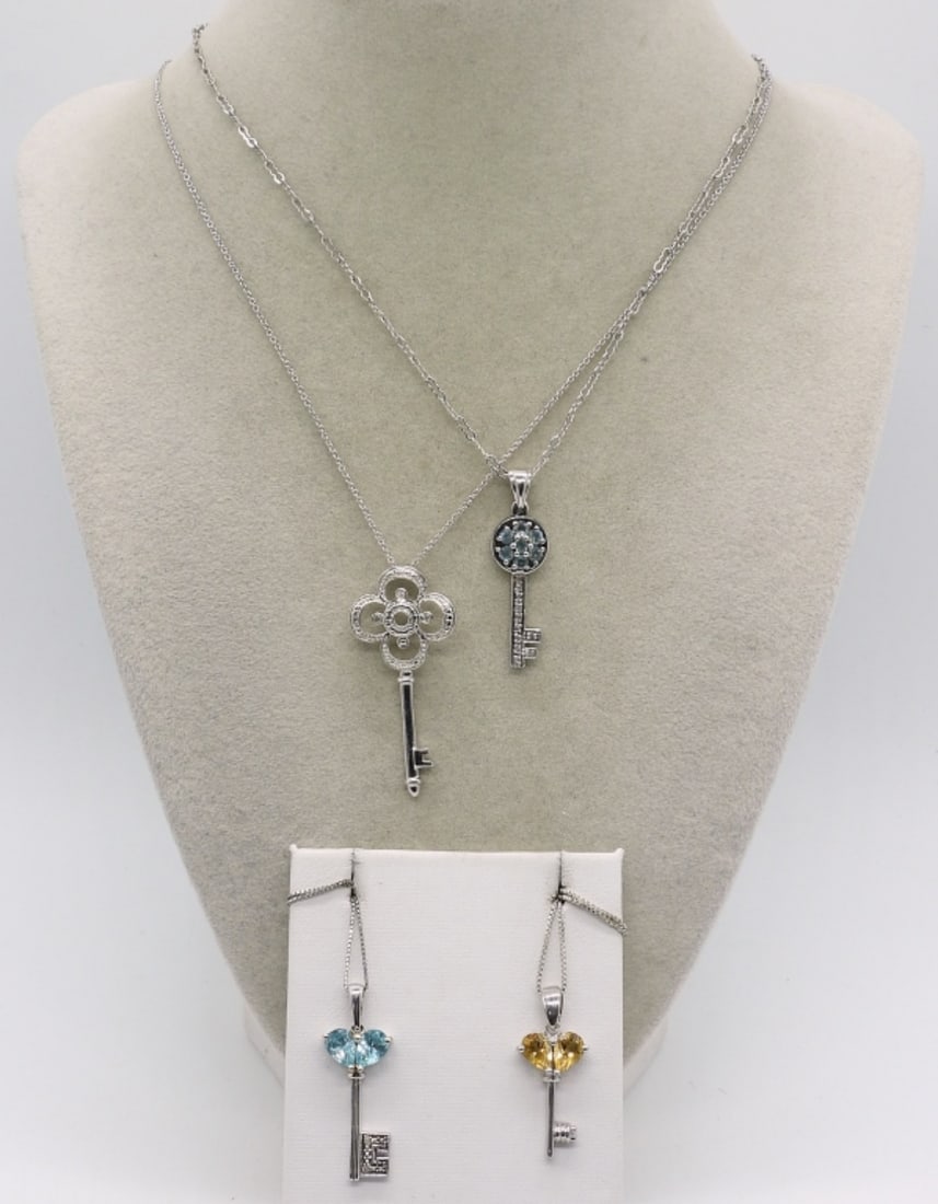 4 Cute Sterling Skeleton Key Necklaces: Four cute sterling skeleton key necklaces with gemstones. Blue topaz & Citrine. Sterling chains are 18" long. (11 dwt)
