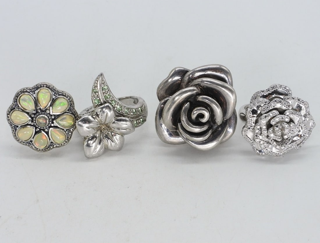 4 Rose Shaped Sterling Rings: Four rose shaped sterling rings, opal. Ring sizes are 7 & 8. (22 dwt)