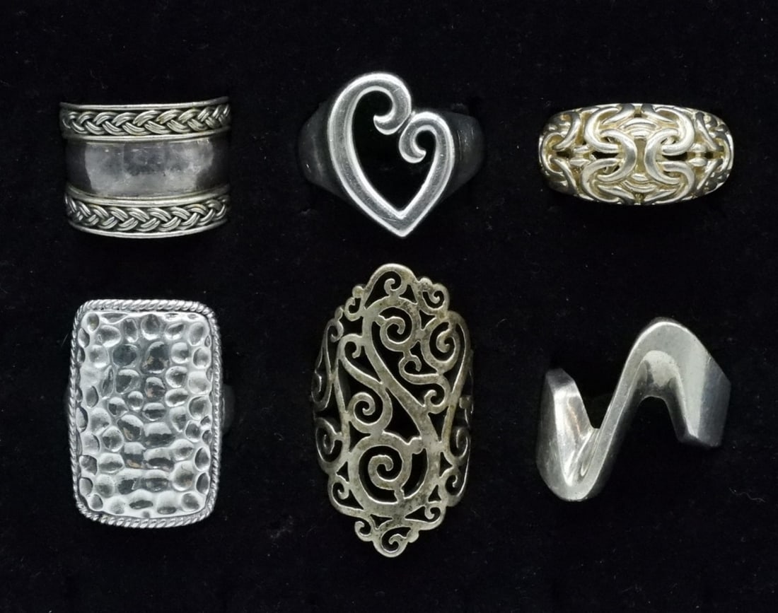6 Sterling Fashion Rings: Six sterling fashion rings, sizes 5-10. (30.5 dwt) (6x4x2)