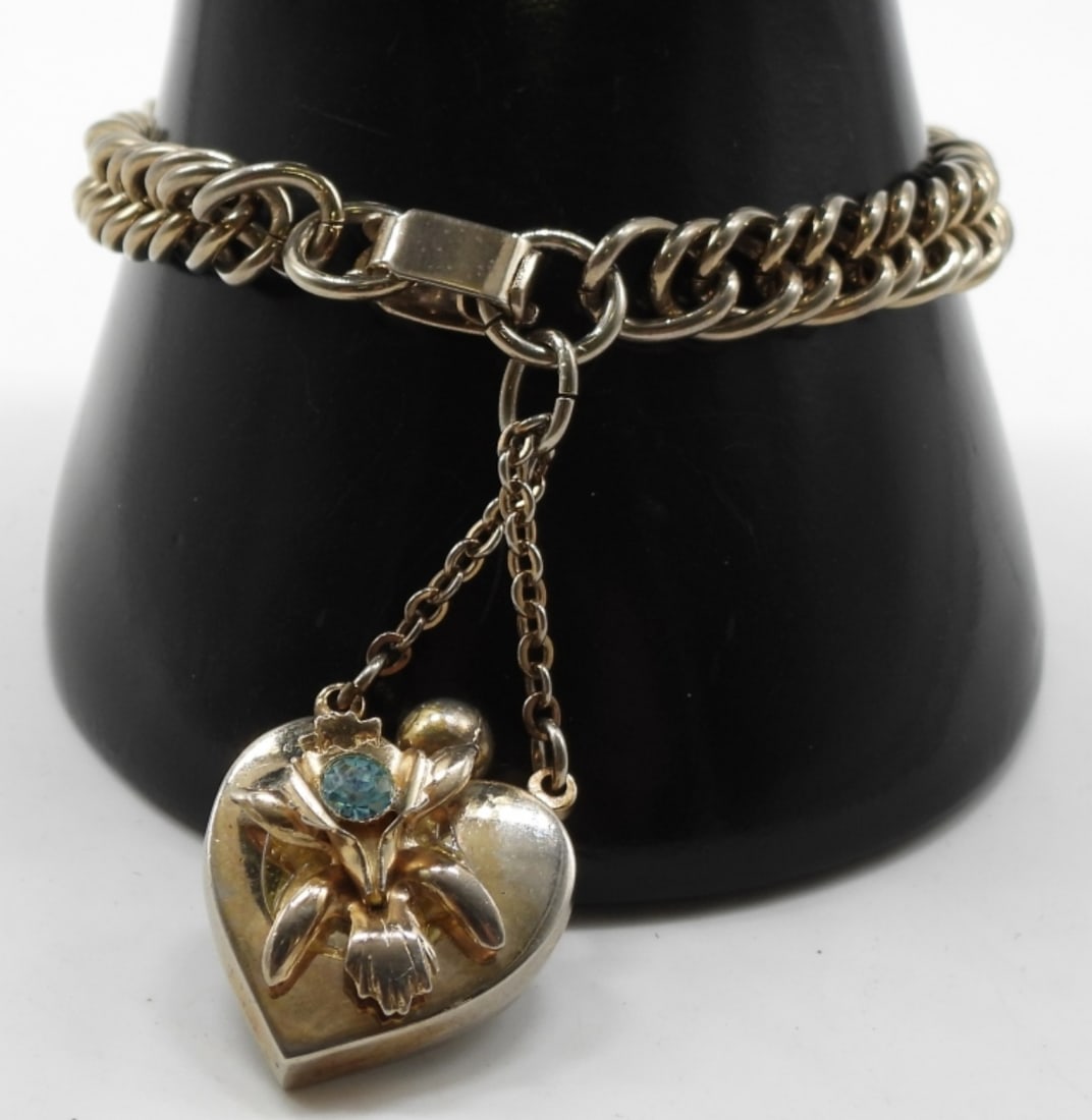 Occupied Urn Bracelet: Silver-tone with a flower and the March birthstone.