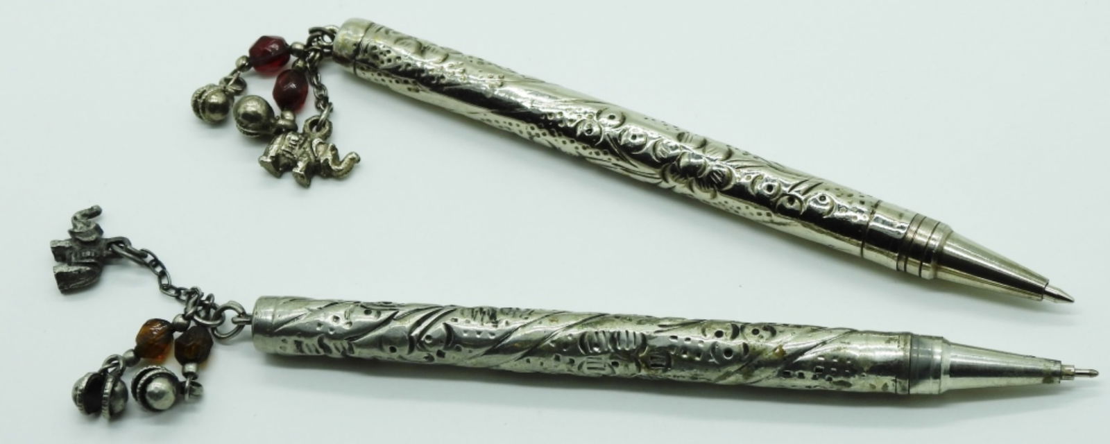 (2) Silver-Tone Charm Ball Point Pens: There are charms on the top of the pen that make noise when you try to use