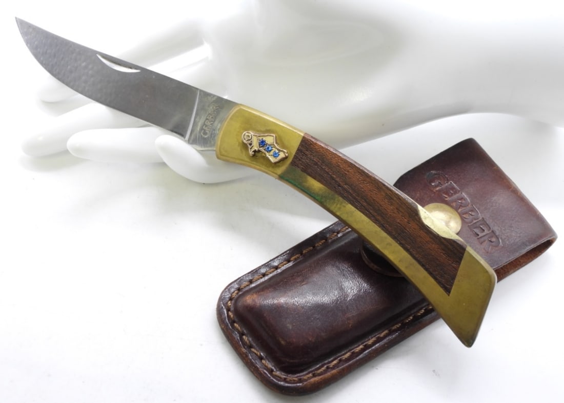 Gerber 97223 Pocket Knife: Lockback, Opens and closes no issue. Comes in sheath