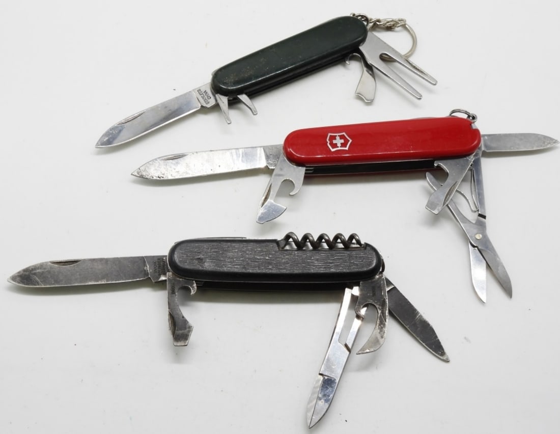 (3) Mixed Brands Of Utility Knives: (1) Is a Swiss Army Knife classic red. (1) Green (1) Black