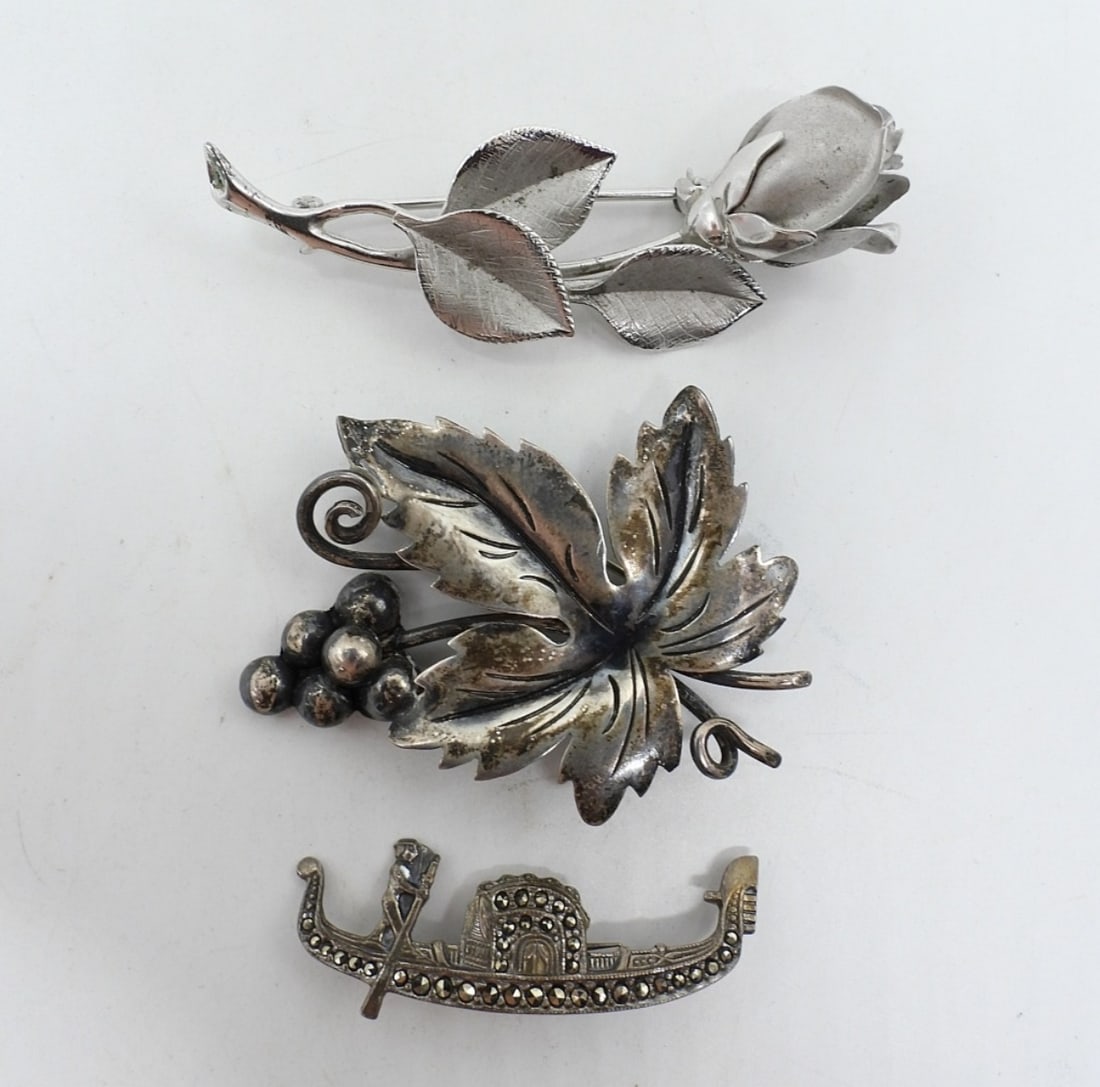 DG Taxco & HSB Sterling Brooches: Damaso Gallegos "DG" Taxco Mexico sterling grape leaf pin, 2" long. HSB sterling rose pin, 2.5" long. Marcasite boat pin, 2" wide. (13.2 dwt)