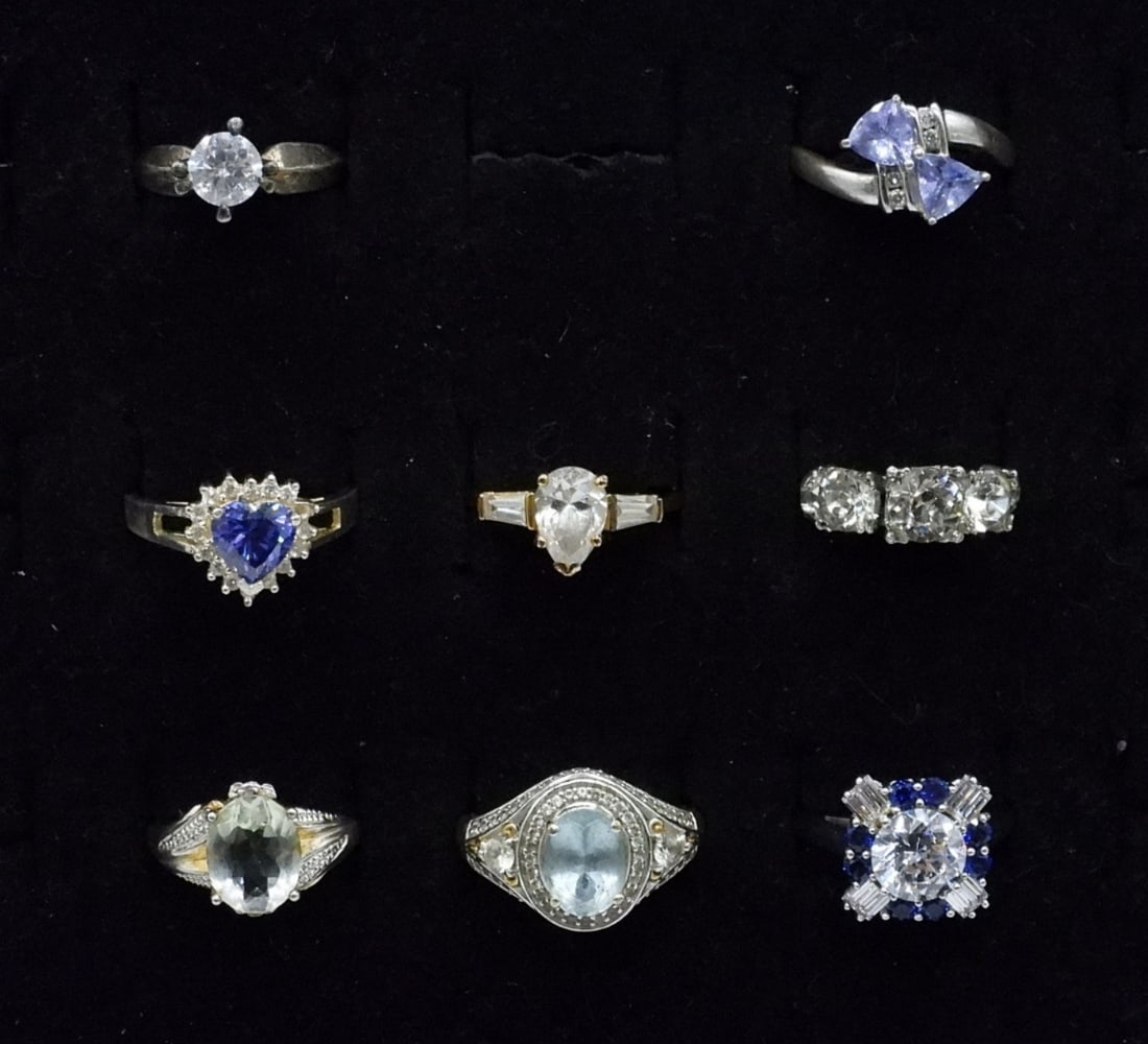 8 Sterling Gemstone Fashion: Eight sterling gemstone fashion rings, sizes 4.5 - 8. Amethyst, Simulated Diamond, Blue Topaz, Simulated Sapphire. (17.9 dwt)