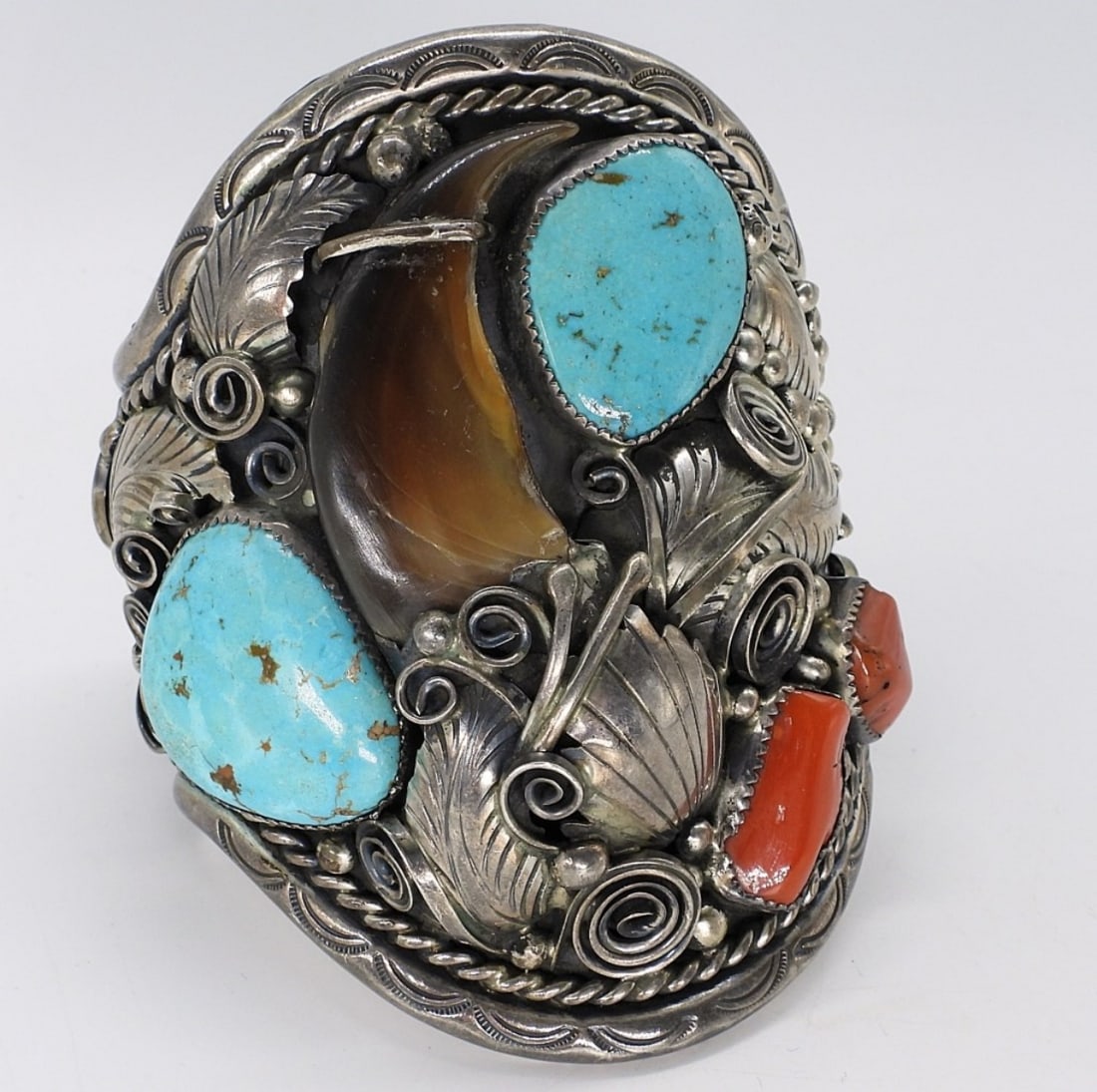 Navajo, M. Thomas Large Cuff Bracelet: Navajo artist, M. Thomas large cuff bracelet. Turquoise and red coral gemstones. Bear claw as well. Inside of cuff measures approximately 8" around. Top part of the cuff measures 4" long. Gemstones ar