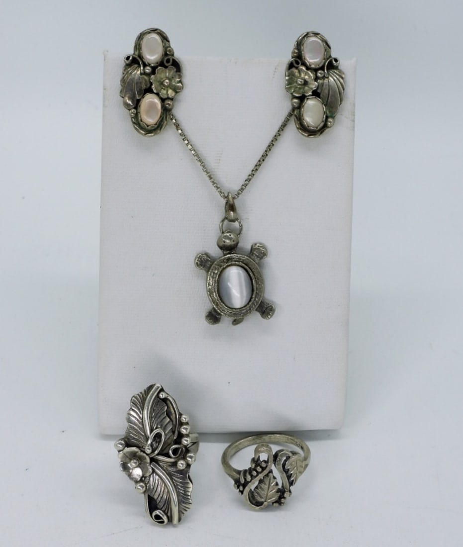 Gorgeous Mother of Pearl 925 Set & Ring: Gorgeous sterling clip on earrings, with mother of pearl gemstones, 1" long. Two sterling rings, size 5 & 7. Turtle shaped sterling necklace with Gray Cats Eye gemstone, 20" chain. (16 dwt)