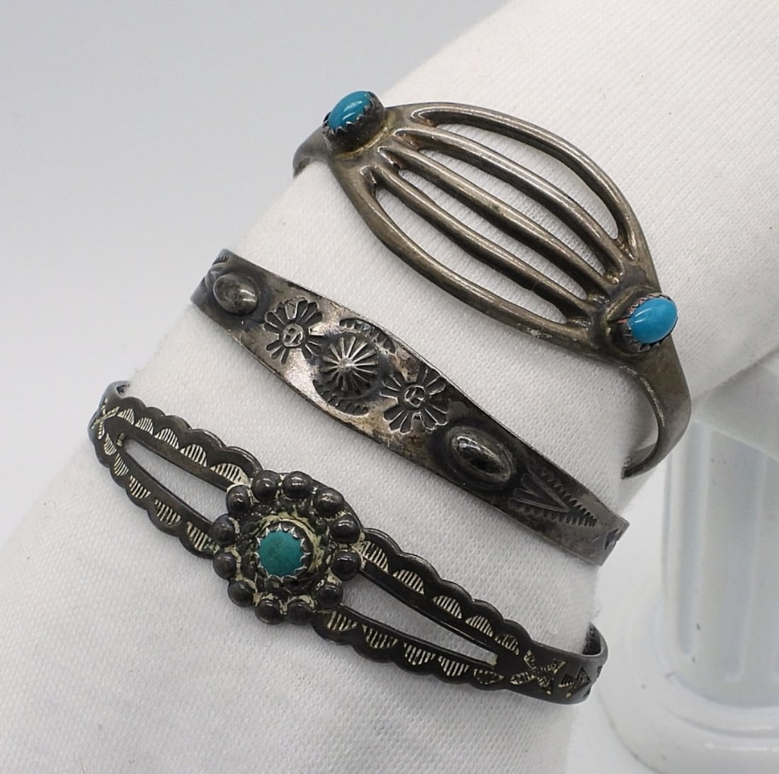 3 Petite Sterling Turquoise Cuff Bracelets: Three petite sterling cuff bracelets with turquoise gemstones. 5". (16.4 dwt)
