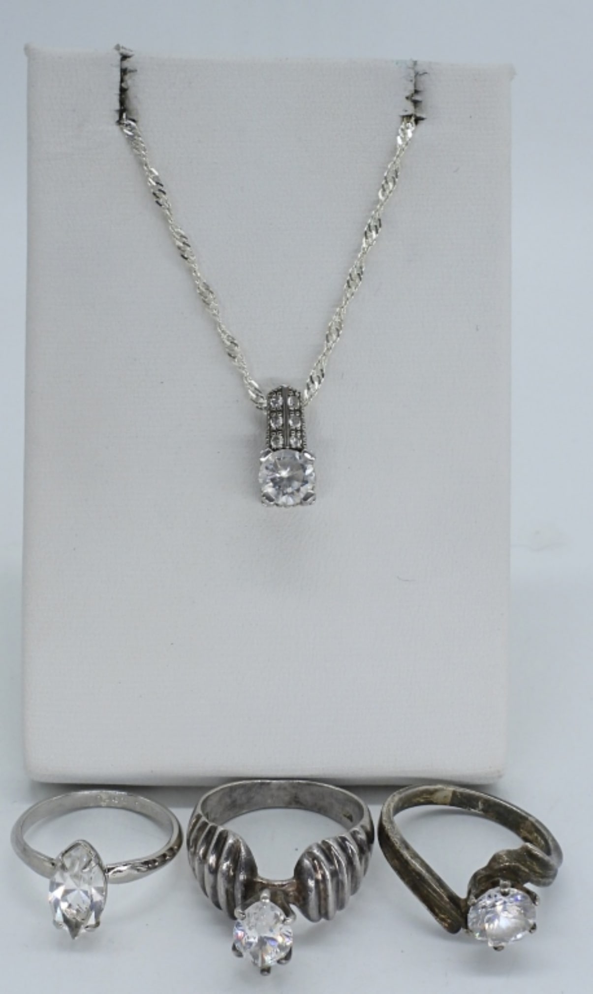 Simulated Diamond 925 Rings & Necklace: Simulated diamond sterling rings, sizes 6.5, 7, 8. Necklace is 18" long. (9 dwt)